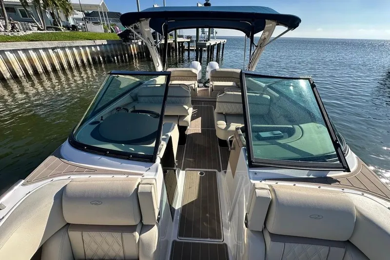 Slide: The Image of 2019 Regal 29 OBX boat with spacious seating, docked by the water. - 41