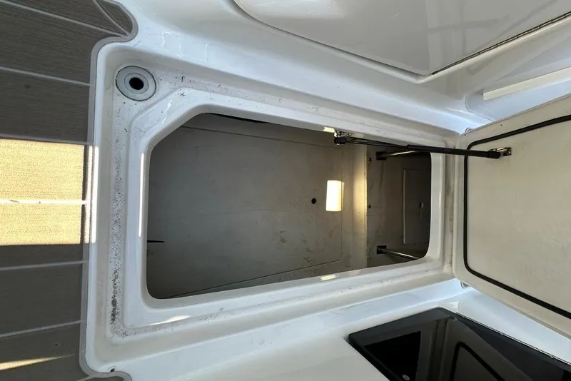 Slide: The Image of Open storage compartment on a 2019 Regal 29 OBX boat, showcasing interior space. - 45