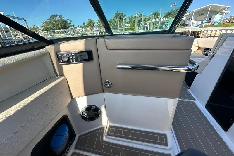 Slide: The Image of Interior view of a 2019 Regal 29 OBX boat, featuring a control panel and seating area. - 46
