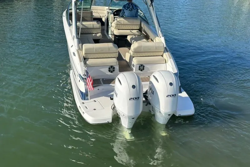 Slide: The Image of 2019 Regal 29 OBX boat with twin Yamaha 200 engines on calm water. - 5