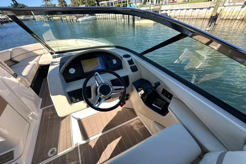 Slide: The Image of 2019 Regal 29 OBX boat cockpit with steering wheel and navigation system. - 54