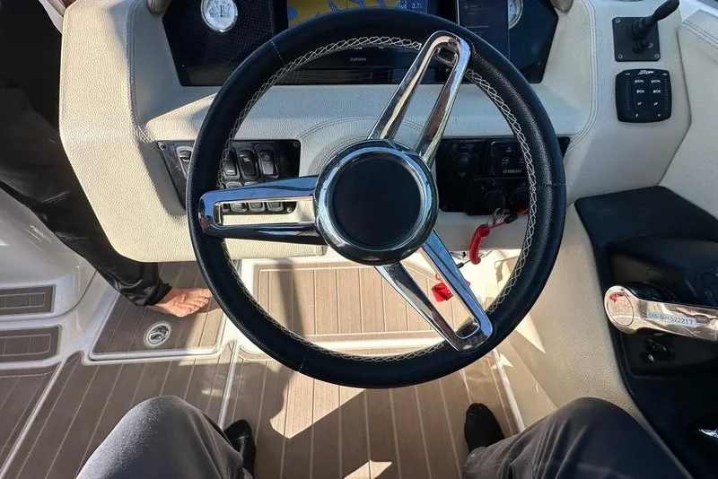 Slide: The Image of Steering wheel of a 2019 Regal 29 OBX boat, featuring modern controls and dashboard. - 55
