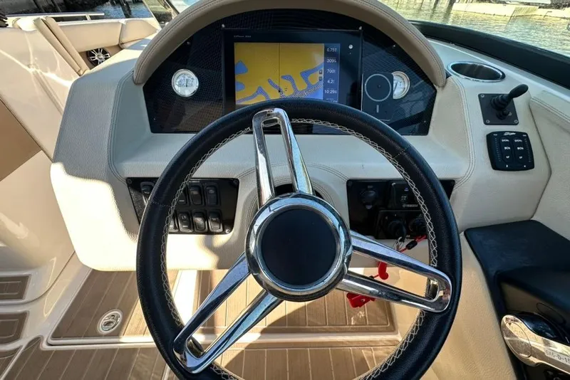 Slide: The Image of 2019 Regal 29 OBX boat dashboard with steering wheel and navigation display. - 56