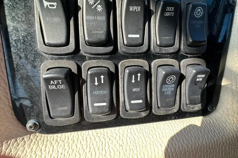 Slide: The Image of Control panel switches on a 2019 Regal 29 OBX boat dashboard. - 58