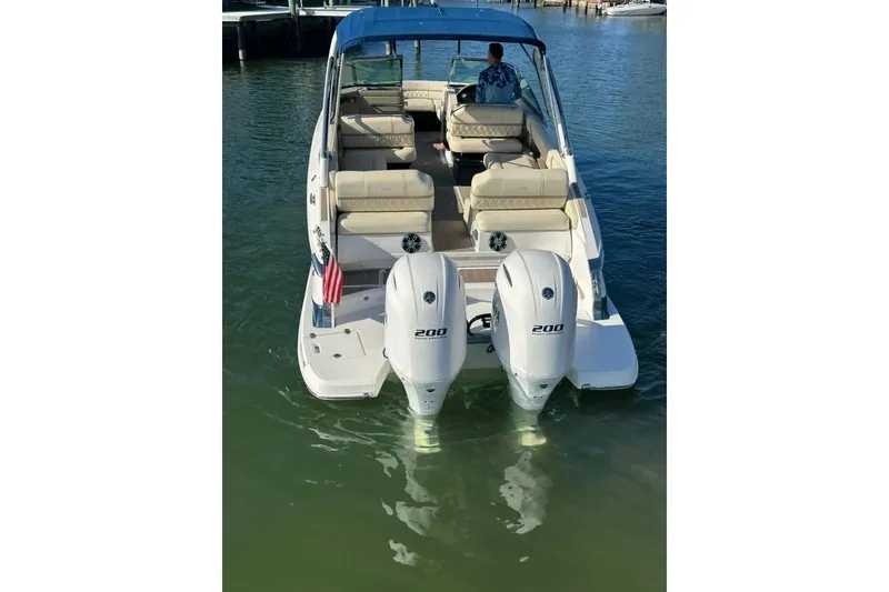 Slide: The Image of 2019 Regal 29 OBX boat with dual 200 horsepower engines on calm water. - 6