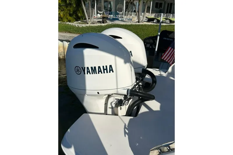Slide: The Image of 2019 Regal 29 OBX with dual Yamaha outboard motors docked by the water. - 70