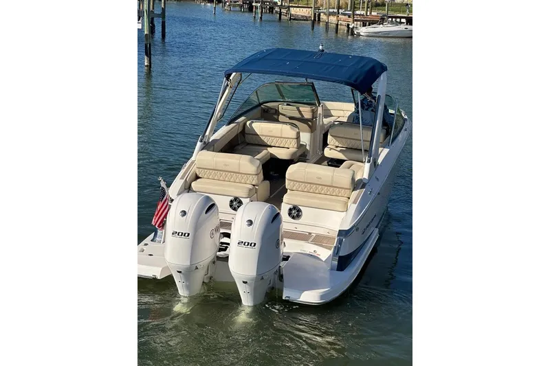 Slide: The Image of 2019 Regal 29 OBX boat with dual engines, docked on calm water. - 9