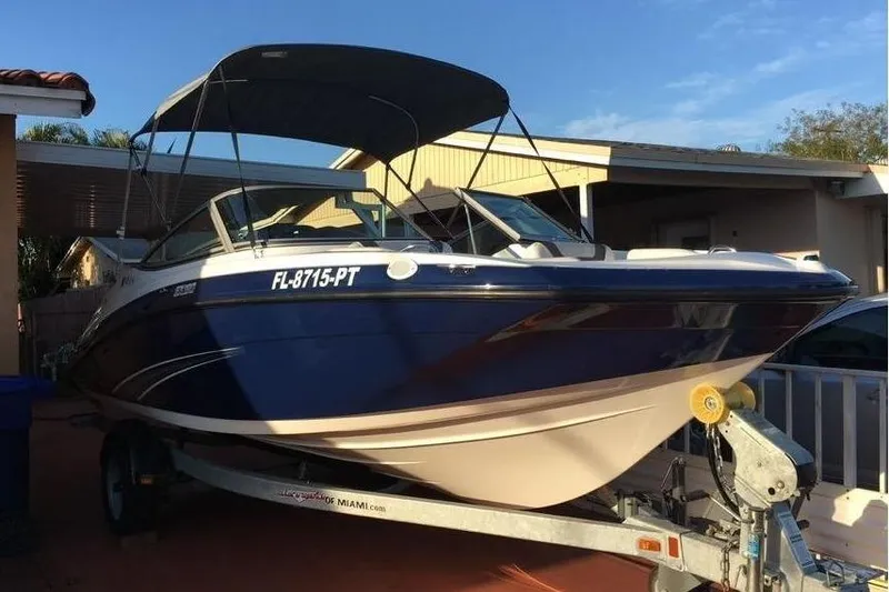 Slide: The Image of 2014 Yamaha SX190 boat on trailer, blue hull, sunshade. - 12