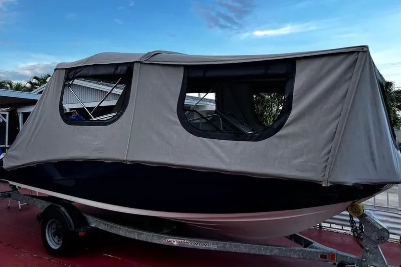 Slide: The Image of 2014 Yamaha SX190 boat with gray cover on trailer. - 15