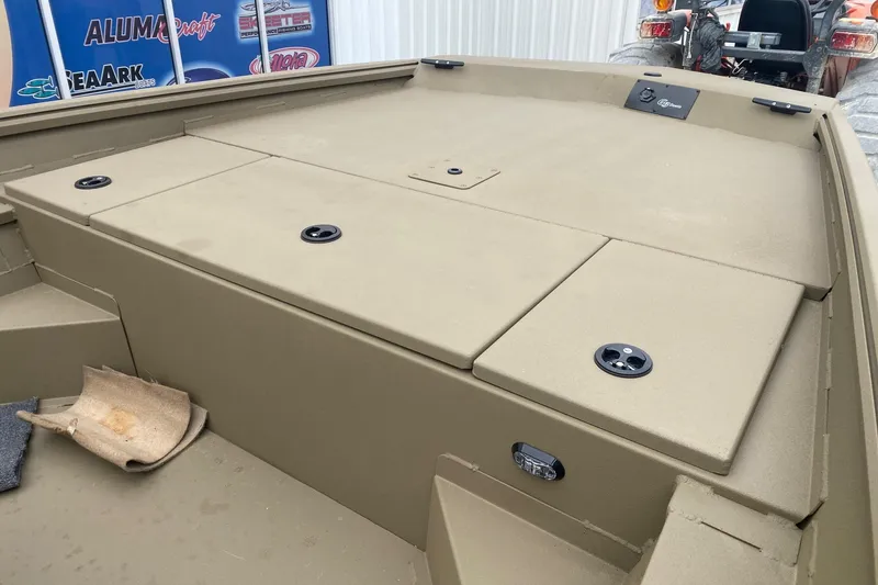 Slide: The Image of 2026 G3 Gator Tough 18 CC boat deck with storage compartments and fishing rod holders. - 9