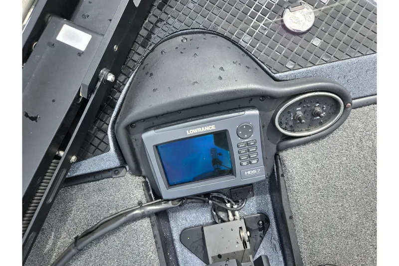 Slide: The Image of 2014 Triton 19XS boat dashboard with Lowrance HDS-7 fishfinder and control panel. - 19