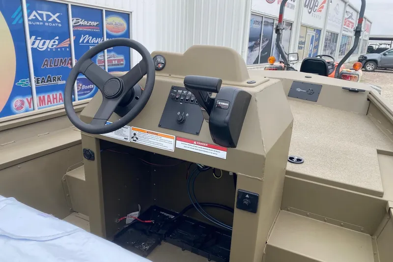 Slide: The Image of 2026 G3 Gator Tough 17 CCJ boat interior with steering wheel and controls. - 6