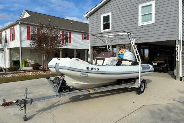 Slide: The Image of 2021 Highfield Sport 520 boat on trailer in residential driveway. - 5