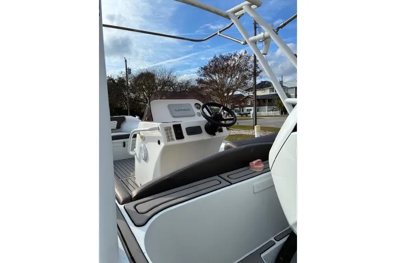 Slide: The Image of 2021 Highfield Sport 520 boat interior with steering wheel and Garmin navigation system. - 8