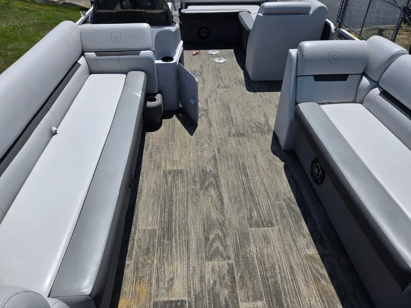 Slide: The Image of Interior of 2021 Godfrey SWEETWATER 2286 SFL pontoon boat with gray seating and wood-style flooring. - 10