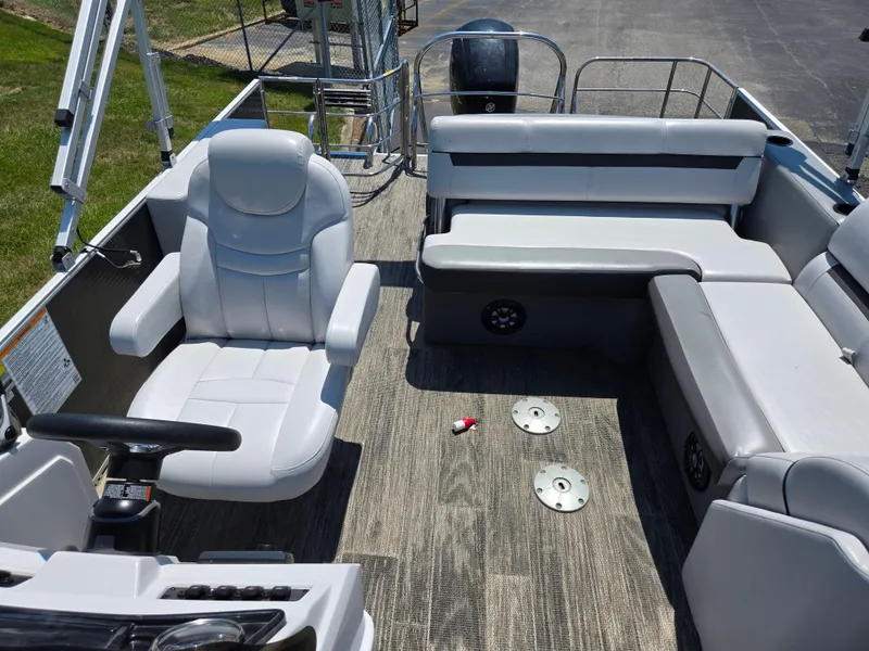 Slide: The Image of 2021 Godfrey SWEETWATER 2286 SFL pontoon boat interior with gray seating and steering console. - 13