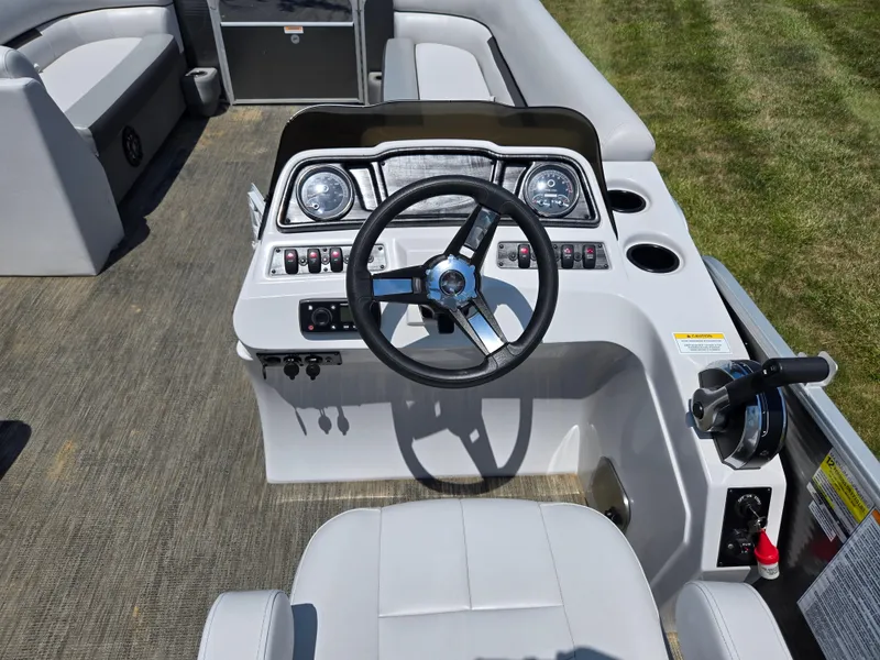 Slide: The Image of 2021 Godfrey SWEETWATER 2286 SFL boat dashboard with steering wheel and controls. - 21