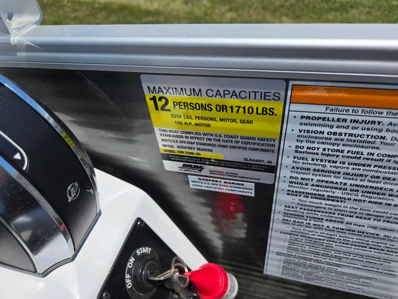Slide: The Image of Capacity label on 2021 Godfrey SWEETWATER 2286 SFL boat, max 12 persons or 1710 lbs. - 22