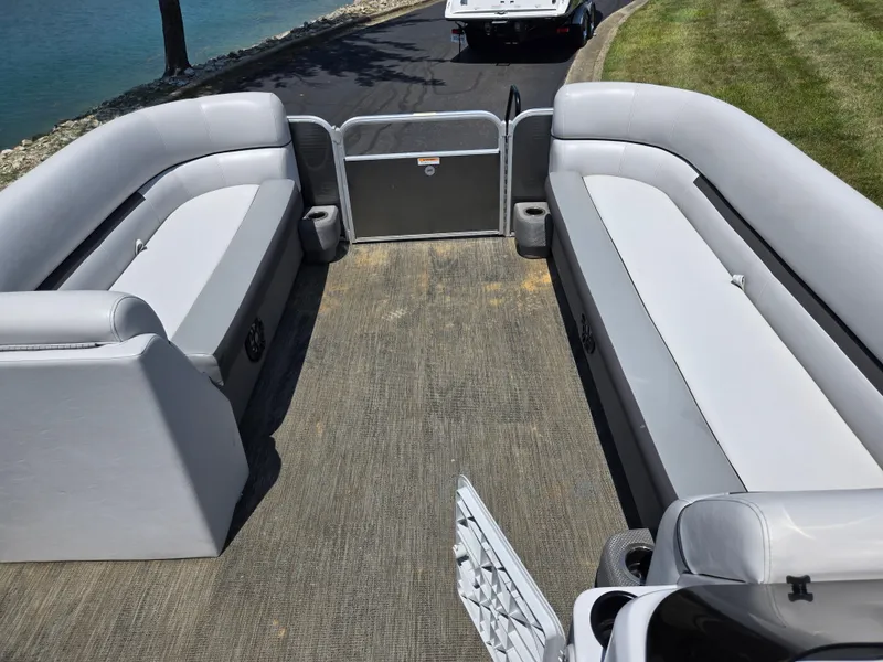 Slide: The Image of 2021 Godfrey SWEETWATER 2286 SFL pontoon boat interior with gray seating and lake view. - 24
