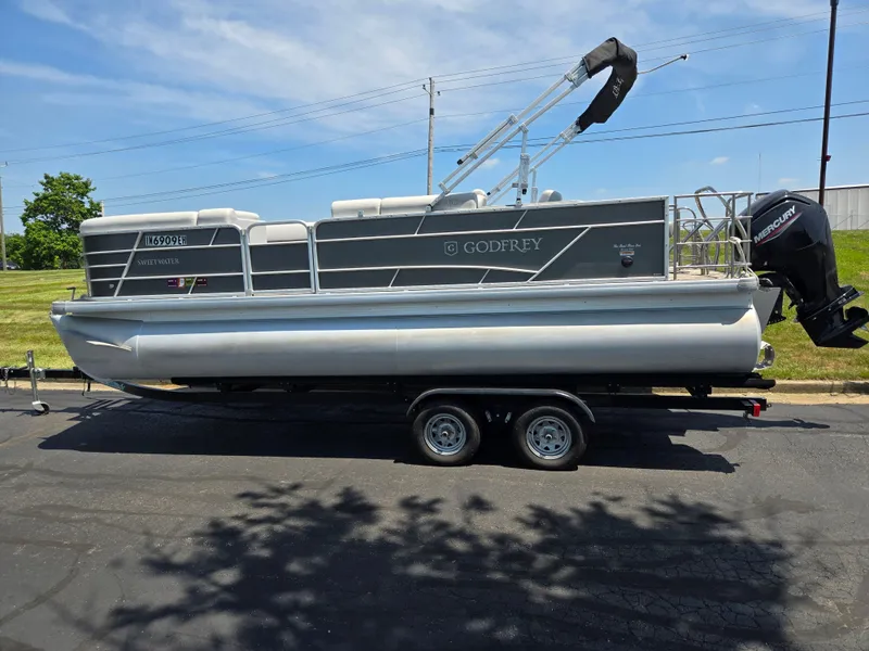 Slide: The Image of 2021 Godfrey SWEETWATER 2286 SFL pontoon boat on trailer, parked outdoors. - 4
