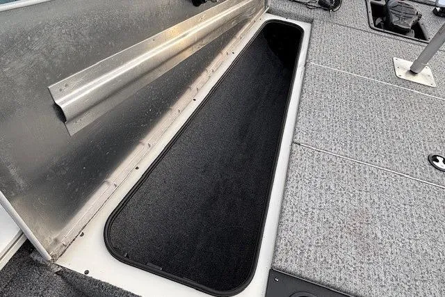 Slide: The Image of 2023 Tracker Pro Team 195 TXW Tournament Edition boat storage compartment, open and empty. - 12