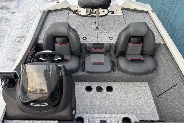 Slide: The Image of 2023 Tracker Pro Team 195 TXW Tournament Edition boat interior with seating and steering console. - 16