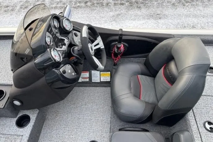 Slide: The Image of 2023 Tracker Pro Team 195 TXW Tournament Edition boat cockpit with steering wheel and gauges. - 17