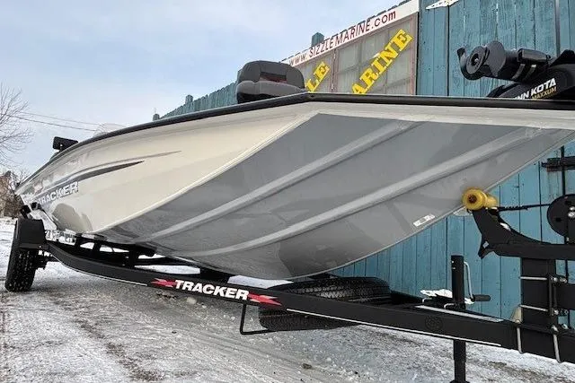 Slide: The Image of 2023 Tracker Pro Team 195 TXW Tournament Edition boat on trailer, displayed outdoors. - 2