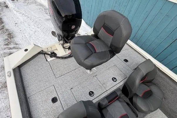 Slide: The Image of 2023 Tracker Pro Team 195 TXW Tournament Edition boat interior with seating and motor. - 23