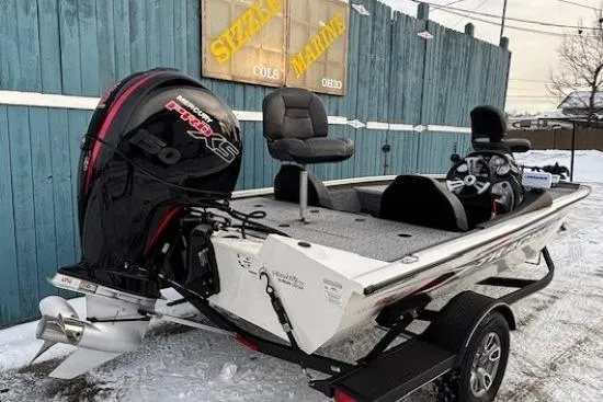 Slide: The Image of 2023 Tracker Pro Team 195 TXW Tournament Edition boat with powerful engine, parked on snowy ground. - 3