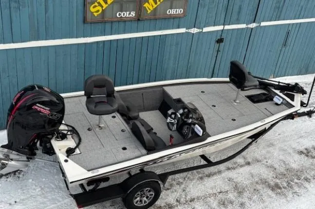 Slide: The Image of 2023 Tracker Pro Team 195 TXW Tournament Edition boat on snowy ground, blue wooden background. - 6