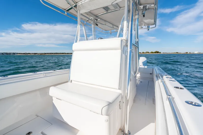 Slide: The Image of 2023 Contender 28 Sport boat on water, featuring sleek white seating and modern design. - 10