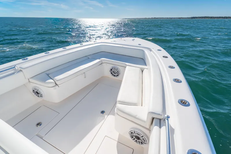 Slide: The Image of 2023 Contender 28 Sport boat with white seating, cruising on open water. - 6