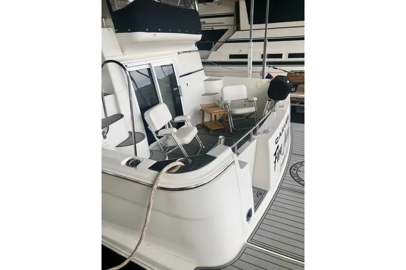 Slide: The Image of 2005 Carver 444 Cockpit Motor Yacht with seating area and deck view. - 21