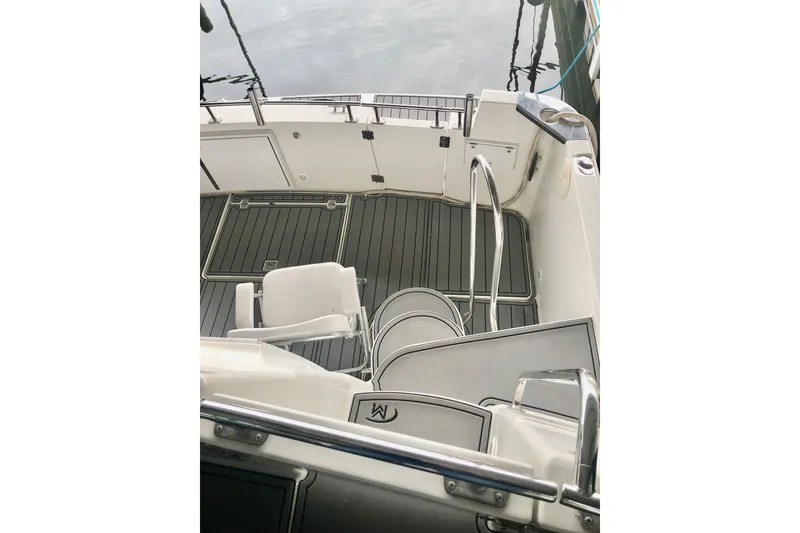 Slide: The Image of 2005 Carver 444 Cockpit Motor Yacht deck with seating and railing. - 23