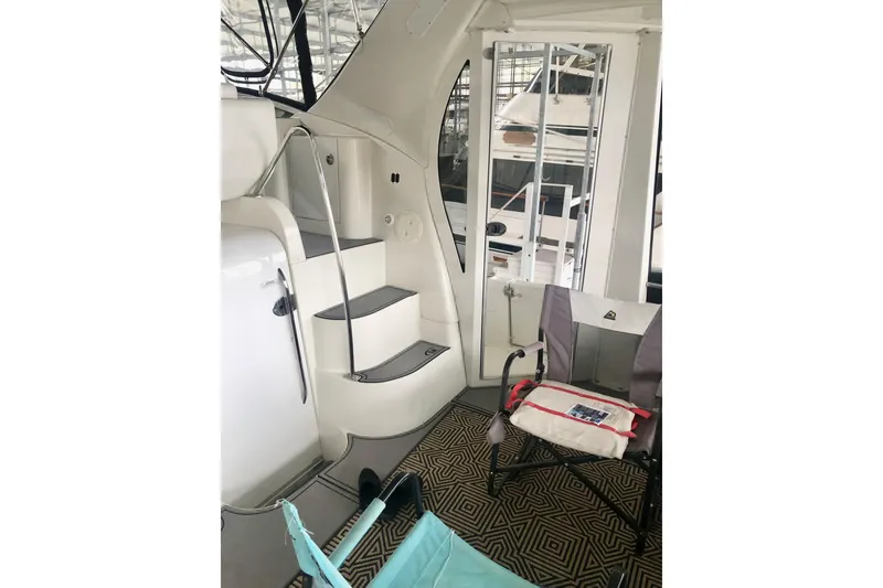 Slide: The Image of 2005 Carver 444 Cockpit Motor Yacht interior with stairs and seating area. - 24