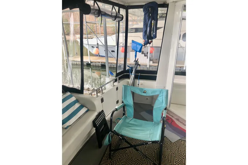 Slide: The Image of 2005 Carver 444 Cockpit Motor Yacht interior with chair and nautical accessories. - 26