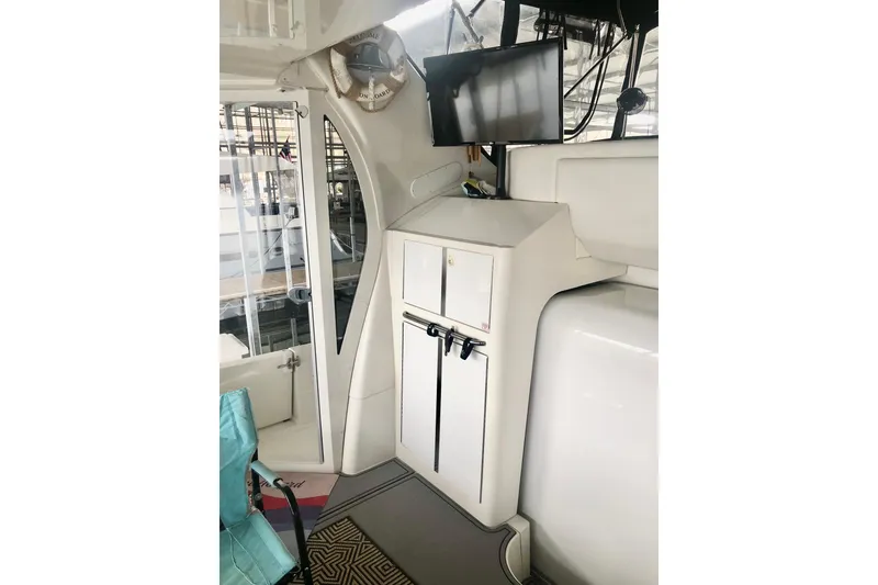 Slide: The Image of 2005 Carver 444 Cockpit Motor Yacht interior with TV and storage cabinets. - 27