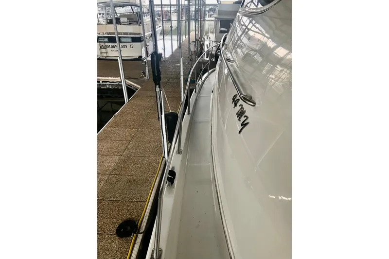 Slide: The Image of 2005 Carver 444 Cockpit Motor Yacht docked in marina, side view. - 28