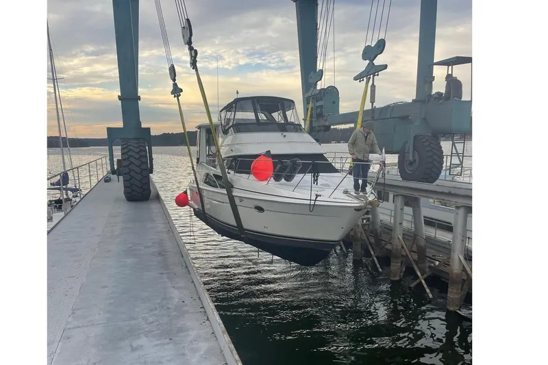 Slide: The Image of Carver 444 Cockpit Motor Yacht 2005 being lowered into water by crane. - 3