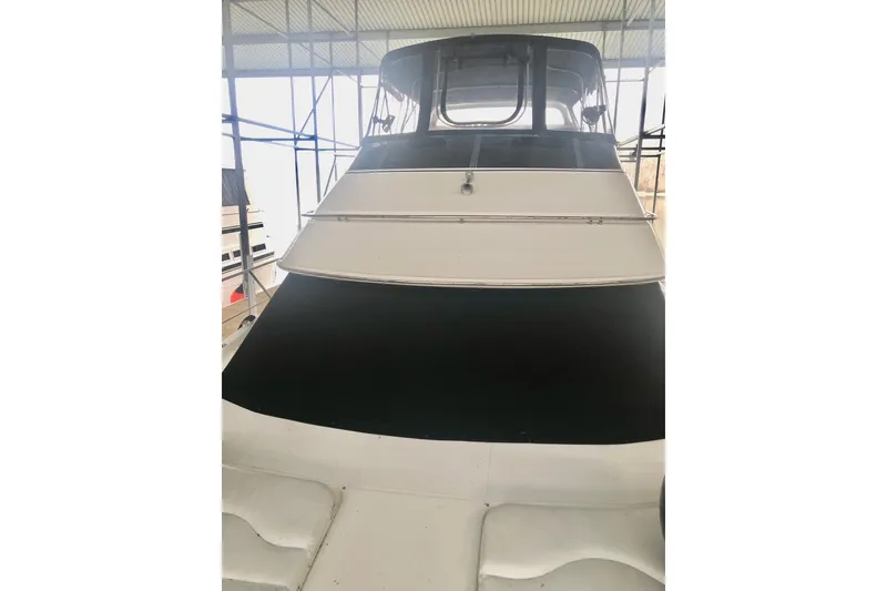 Slide: The Image of 2005 Carver 444 Cockpit Motor Yacht in a covered dock, front view. - 32