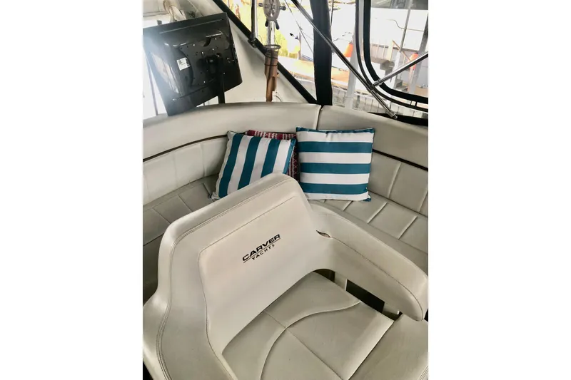 Slide: The Image of 2005 Carver 444 Cockpit Motor Yacht interior with striped cushions and helm seat. - 41