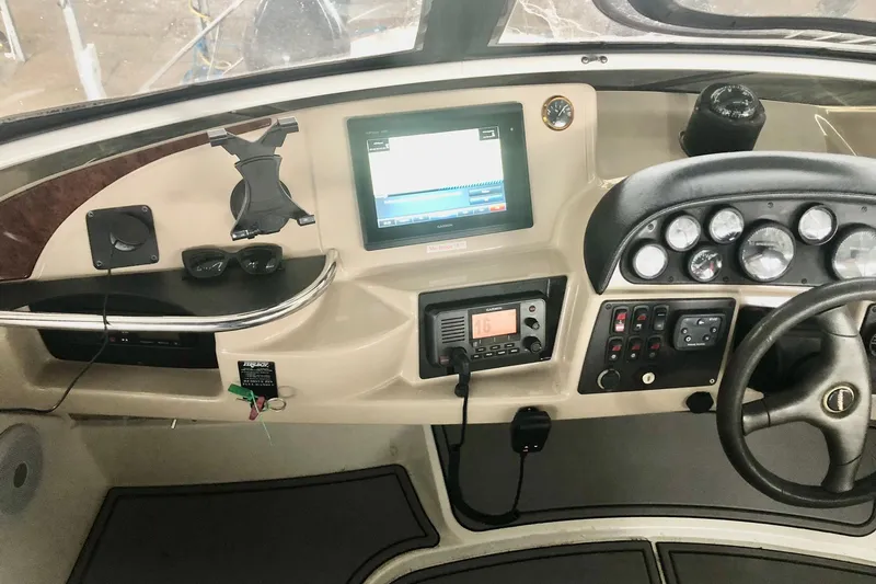 Slide: The Image of 2005 Carver 444 Cockpit Motor Yacht dashboard with navigation and control instruments. - 43
