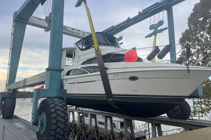 Slide: The Image of 2005 Carver 444 Cockpit Motor Yacht on a travel lift at a marina. - 5