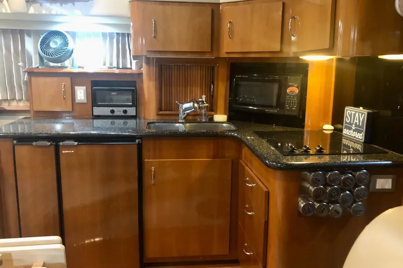 Slide: The Image of Luxurious kitchen in 2005 Carver 444 Cockpit Motor Yacht with modern appliances. - 58