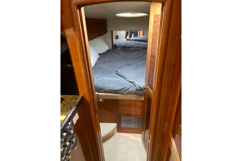 Slide: The Image of Interior cabin of 2005 Carver 444 Cockpit Motor Yacht with cozy bed and wooden finish. - 60
