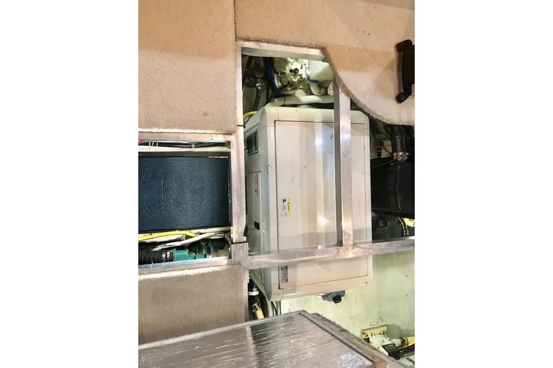 Slide: The Image of Engine compartment of 2005 Carver 444 Cockpit Motor Yacht, showcasing machinery and components. - 87