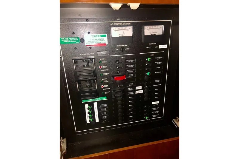Slide: The Image of Electrical control panel of 2005 Carver 444 Cockpit Motor Yacht, featuring switches and meters. - 89