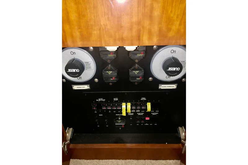 Slide: The Image of Control panel of 2005 Carver 444 Cockpit Motor Yacht with switches and dials. - 90