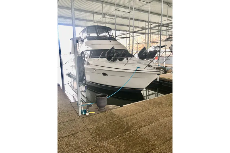 Slide: The Image of 2005 Carver 444 Cockpit Motor Yacht docked in a covered marina. - 19